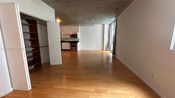 a view of a livingroom with furniture and an empty room