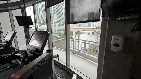 a room with gym equipment and a large window