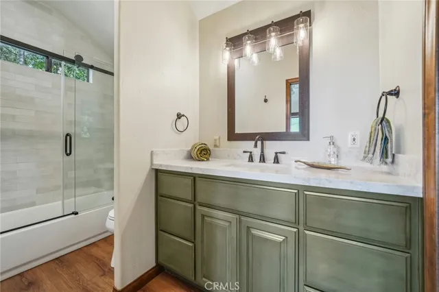 a bathroom with a shower sink and mirror