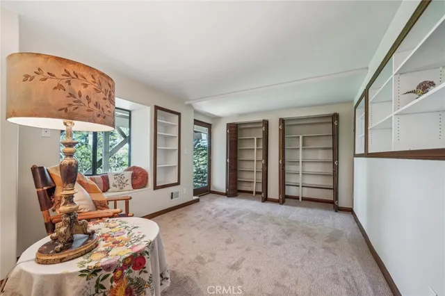 a view of a livingroom with furniture and a window