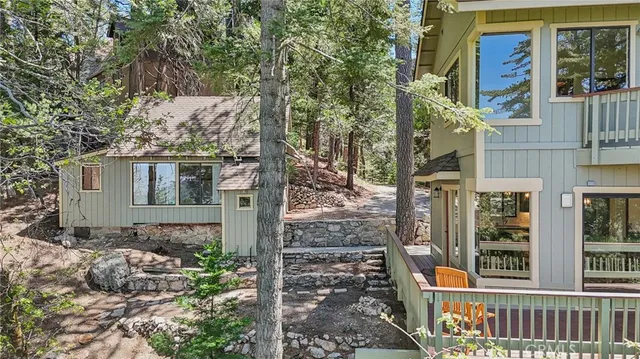a view of a house with a tree front of house