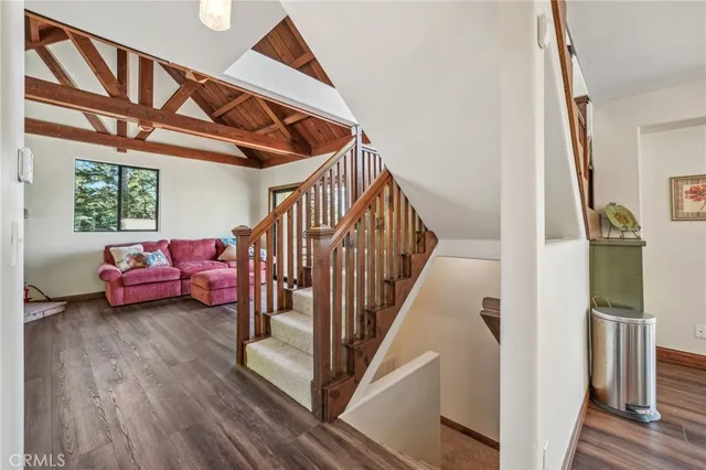 a view of a livingroom with furniture and stairs