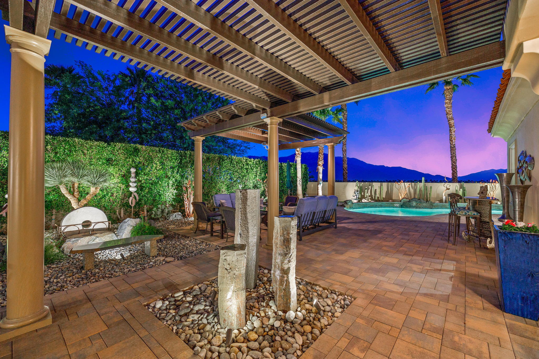 331 Loch Lomond Road Rancho Mirage, CA 92270 - Photo 10 of 37 a view of a patio with table and chairs under an umbrella