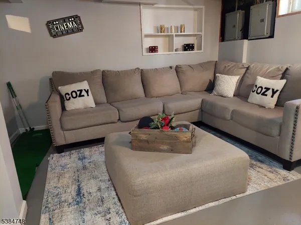 a living room with furniture and a rug