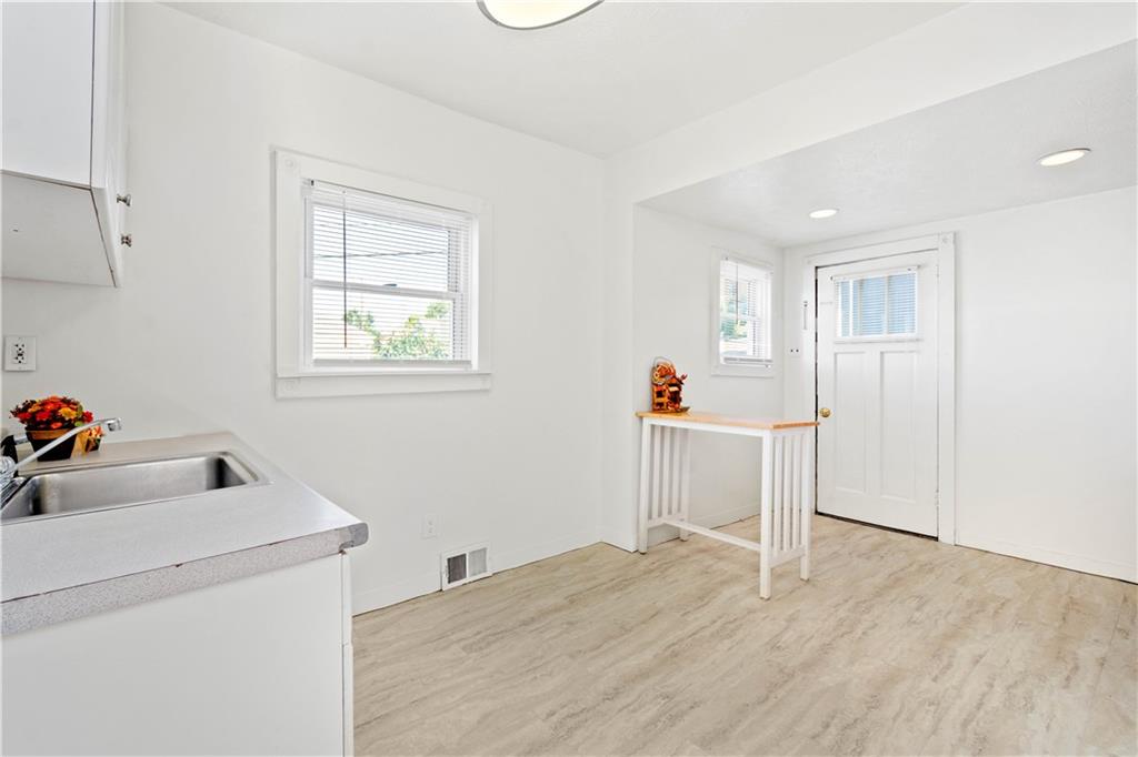 398 Elm Road Ambridge, PA 15003 - Photo 10 of 25 Kitchen features new tile laminate flooring and is clean and bright!
