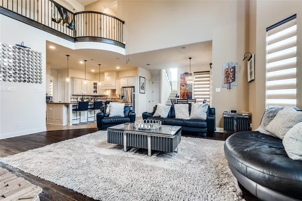 a living room with furniture and kitchen view