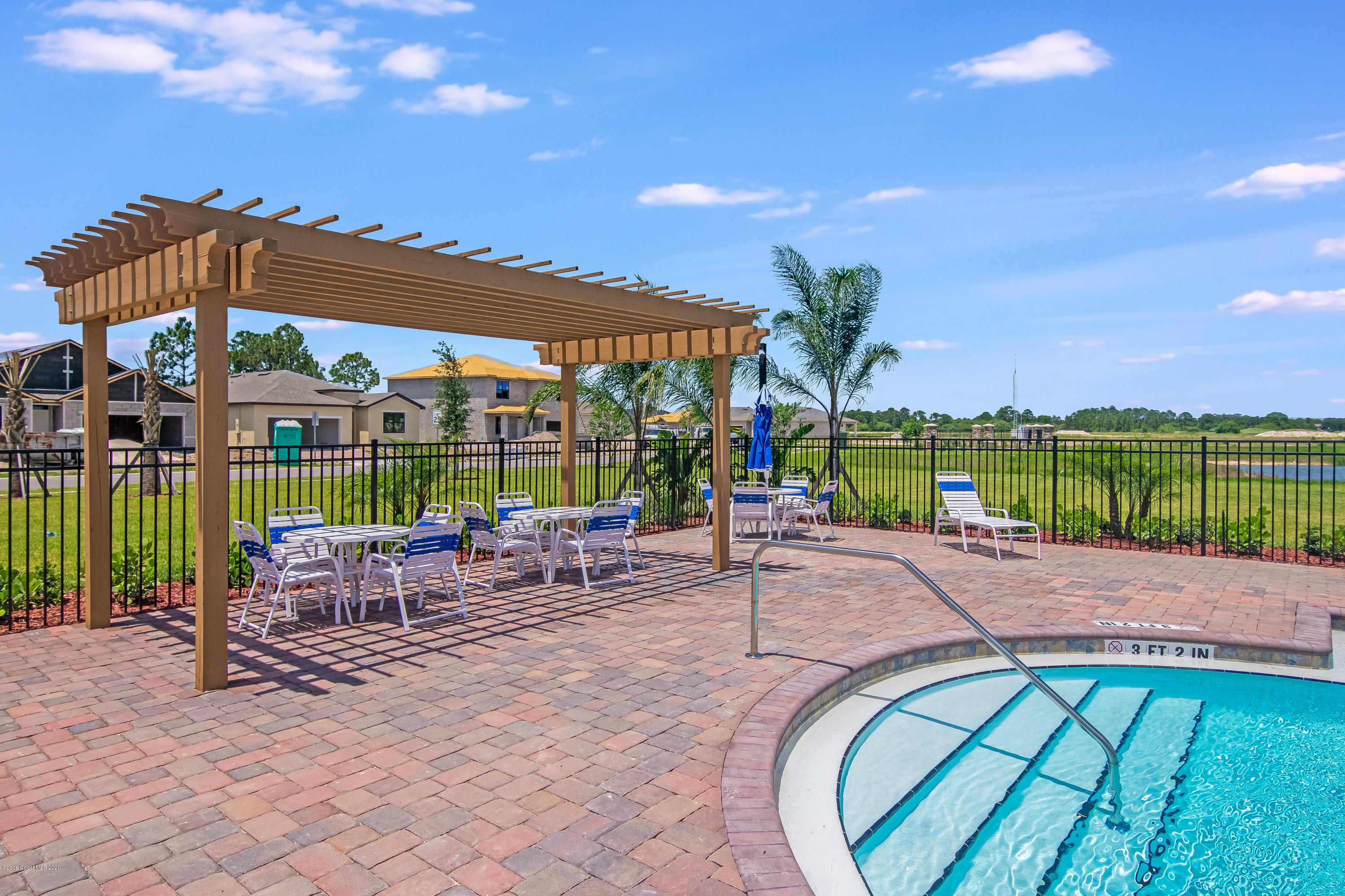 578 Old Country Rd S East Palm Bay, FL 32909 - Photo 22 of 26 a patio with a table and chairs under an umbrella