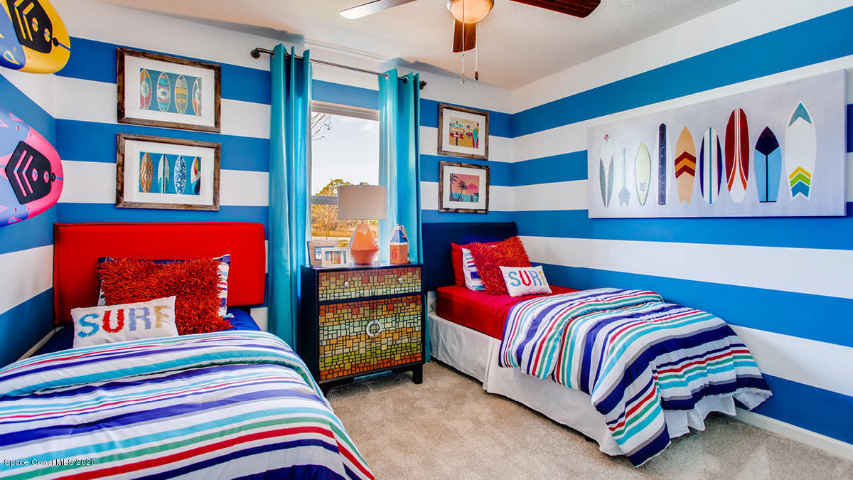 578 Old Country Rd S East Palm Bay, FL 32909 - Photo 10 of 26 a bedroom with a bed and a book shelf