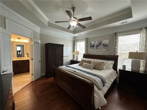 a view of a hallway with furniture and wooden floor
