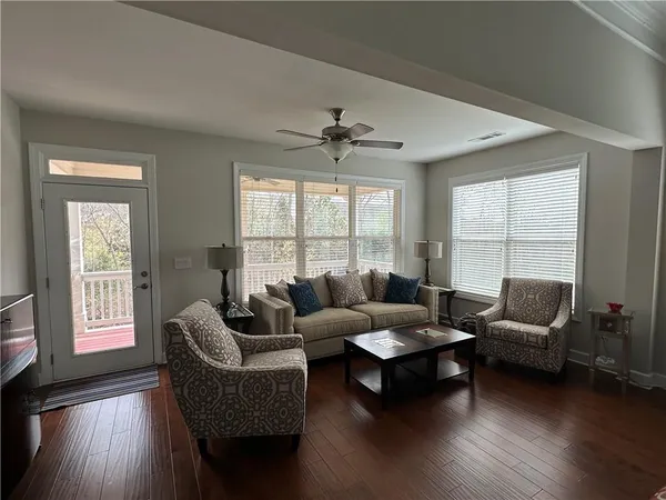 a kitchen with granite countertop stainless steel appliances a stove a sink a microwave a refrigerator and cabinets