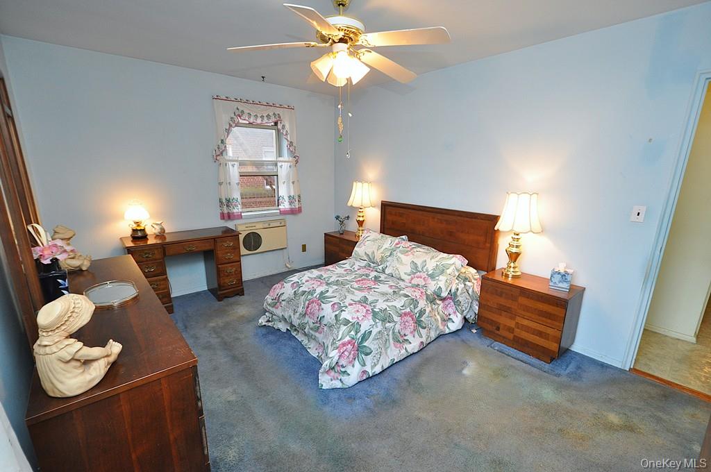 682 Tuckahoe Road, Unit 5H Yonkers, NY 10710 - Photo 13 of 24 a bedroom with a bed and a couch
