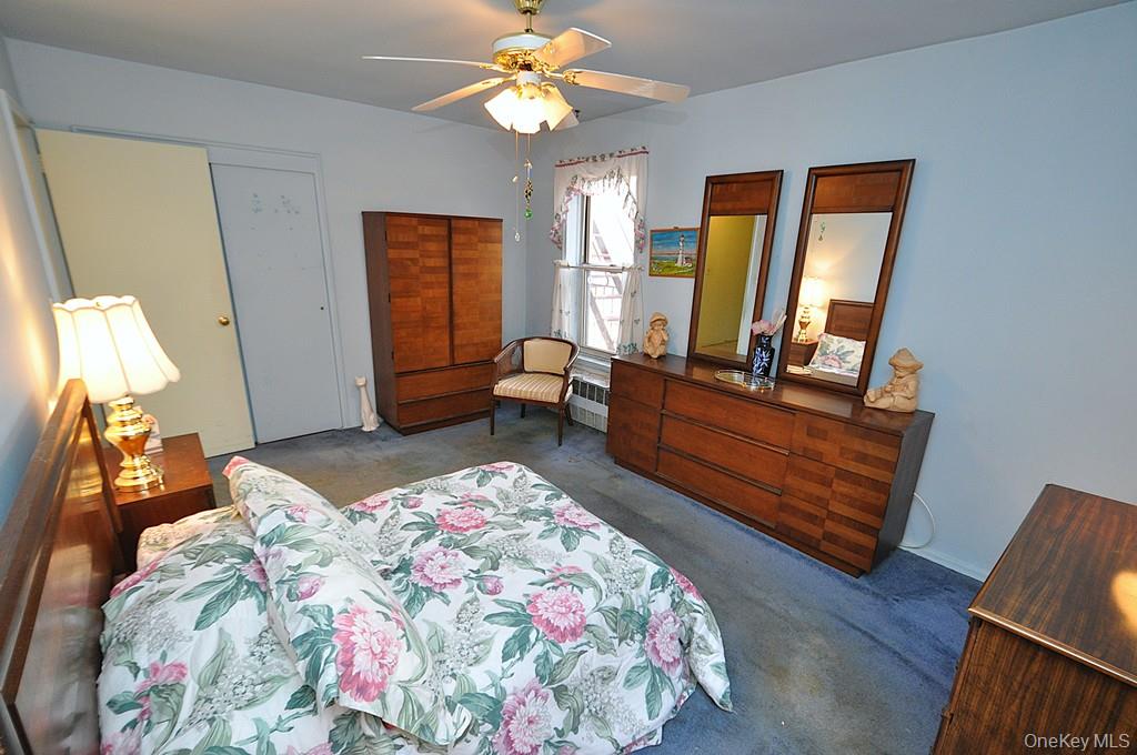 682 Tuckahoe Road, Unit 5H Yonkers, NY 10710 - Photo 15 of 24 a bedroom with a bed and wooden floor