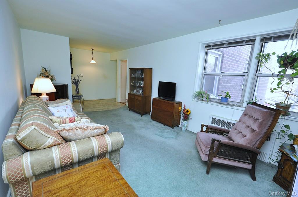 682 Tuckahoe Road, Unit 5H Yonkers, NY 10710 - Photo 3 of 24 a living room with furniture fireplace and a flat screen tv