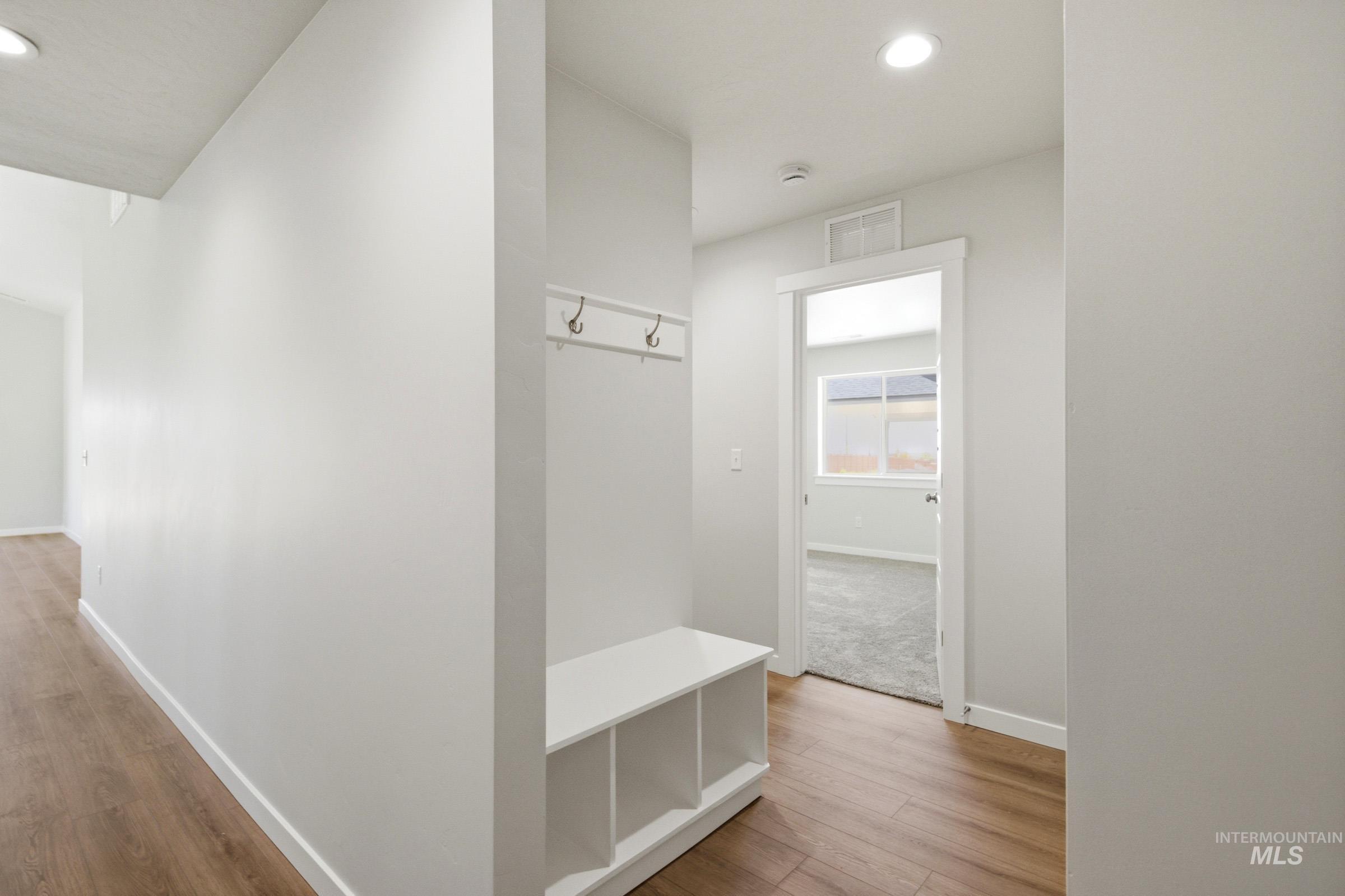 1184 West Jasper Street Meridian, ID 83642 - Photo 13 of 18 Entryway with built-in bench seating featuring cubbies and wall-mounted hooks