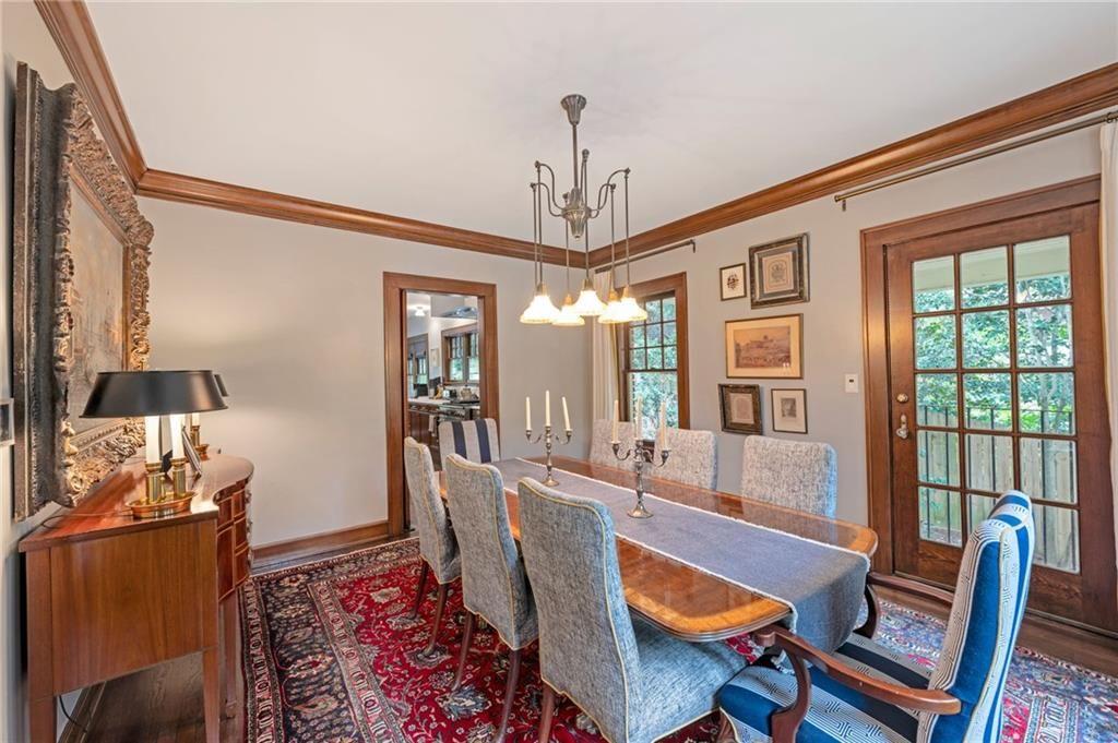 1810 East Clifton Road Northeast Atlanta, GA 30307 - Photo 23 of 50 a dining room with furniture a chandelier and wooden floor