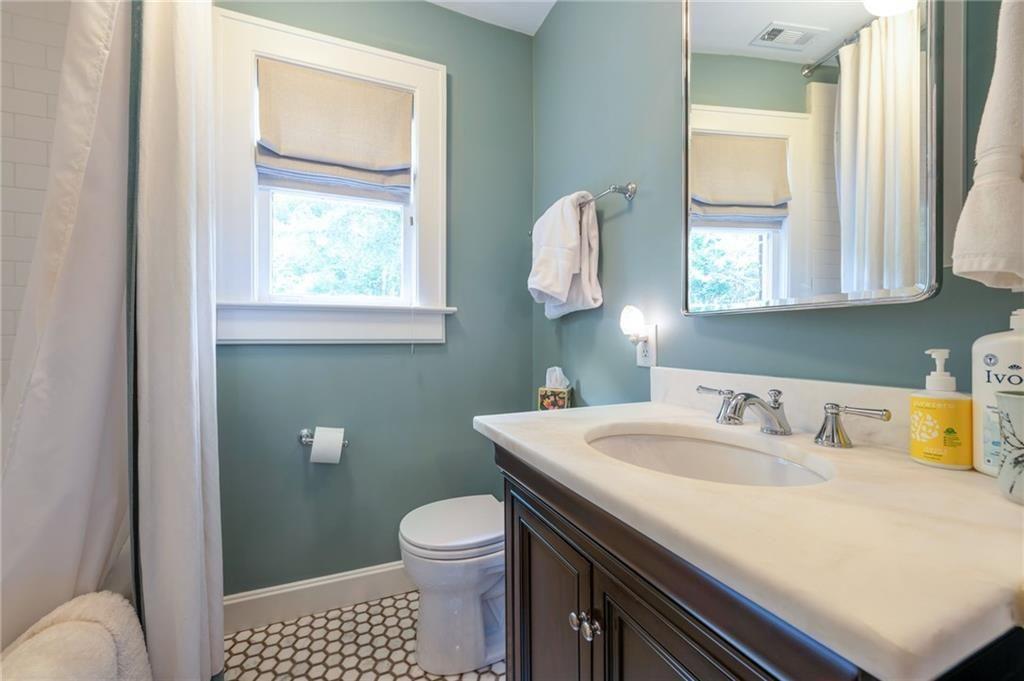 1810 East Clifton Road Northeast Atlanta, GA 30307 - Photo 26 of 50 a bathroom with a sink toilet and mirror