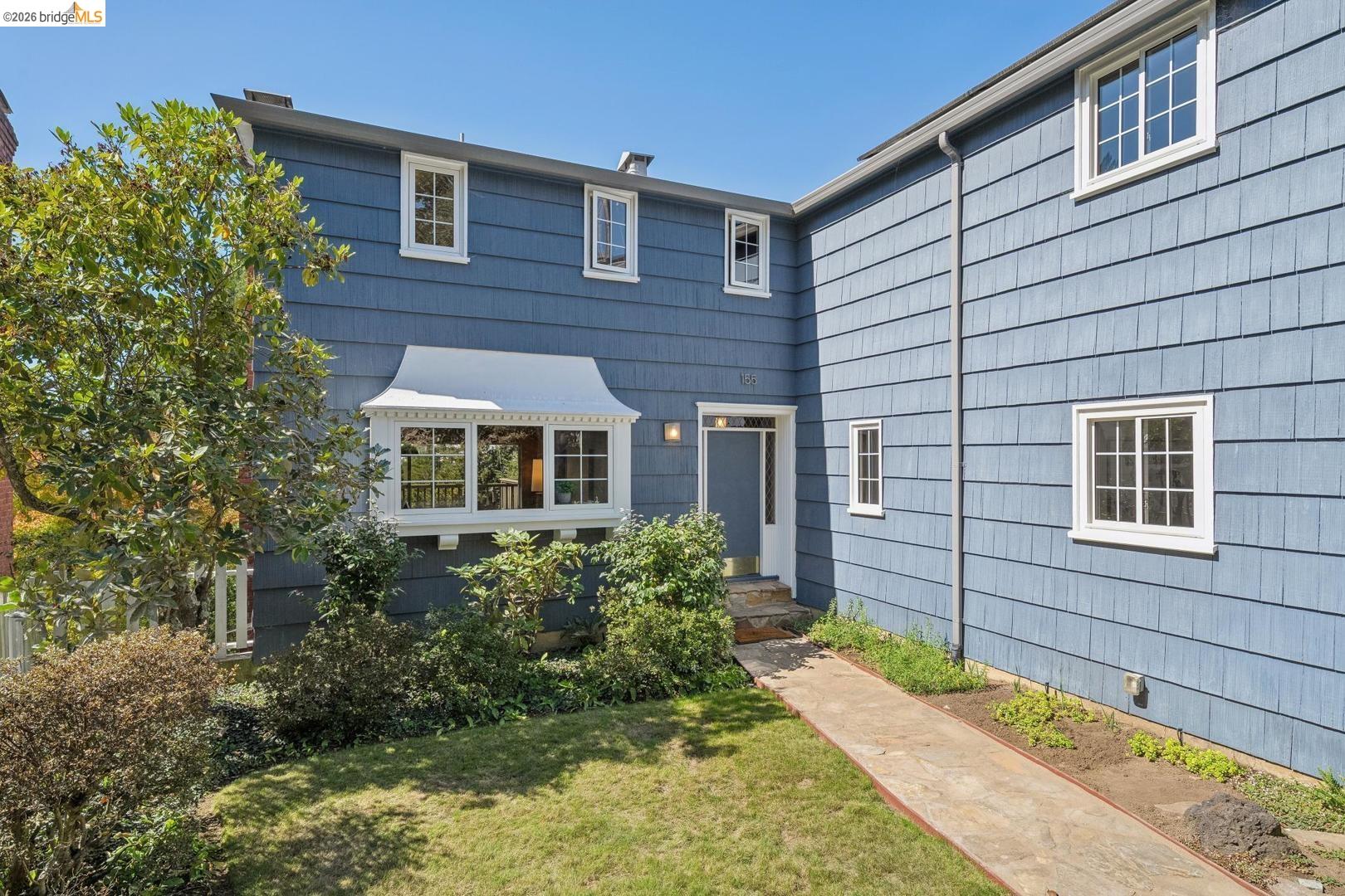 155 Avenida Drive Berkeley, CA 94708 - Photo 2 of 86 Blue shingle siding exterior with white trim windows and a prominent bay window with a decorative overhang