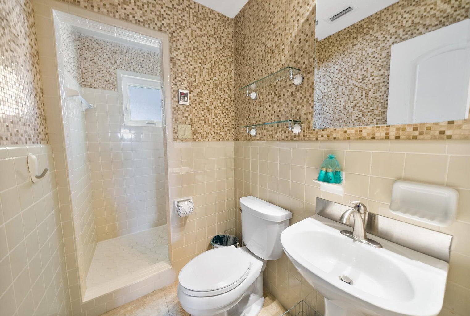 36 Green Street Inlet Beach, FL 32461 - Photo 14 of 29 a white toilet sitting next to a bathroom sink