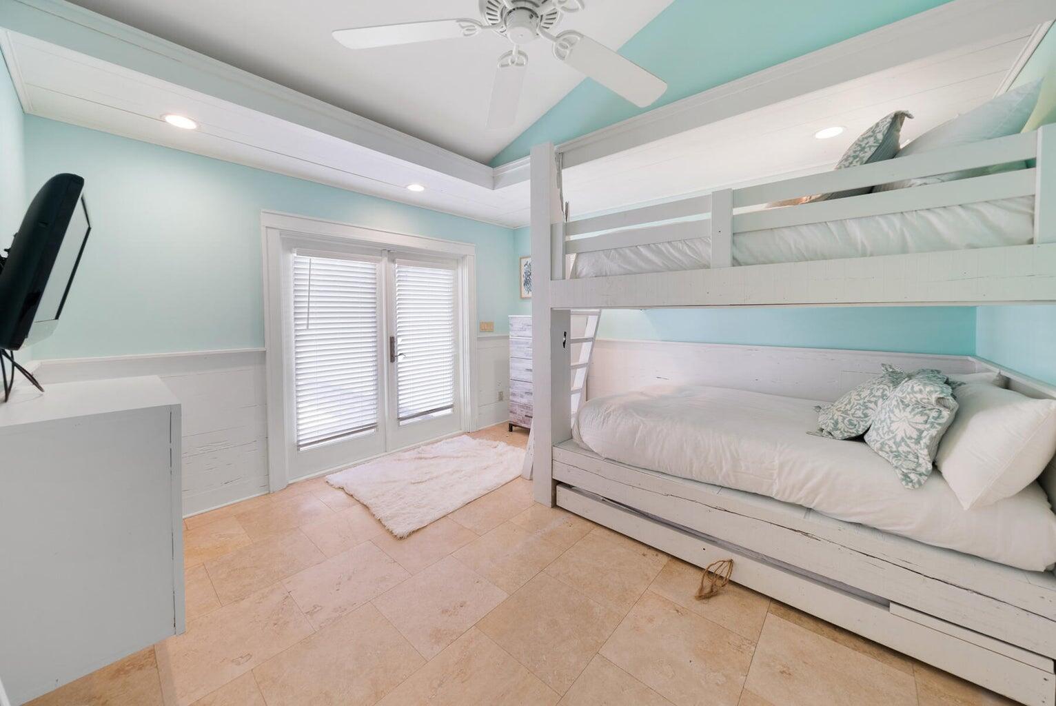 36 Green Street Inlet Beach, FL 32461 - Photo 15 of 29 a spacious bedroom with a bed and a chandelier