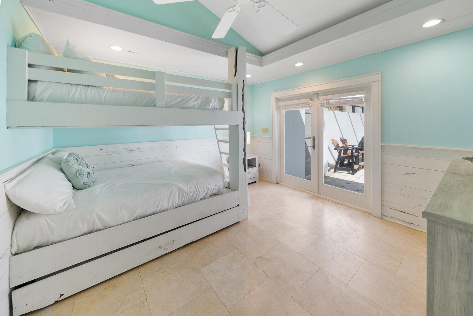 36 Green Street Inlet Beach, FL 32461 - Photo 16 of 29 a spacious bedroom with a bed and a chandelier