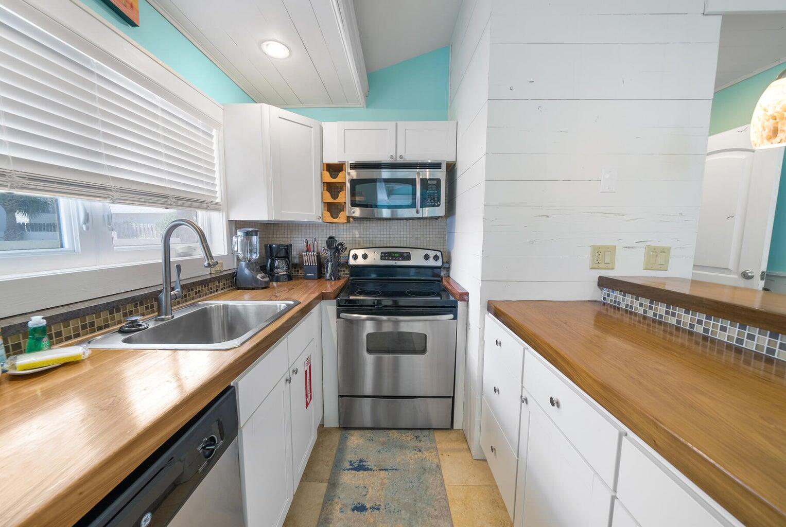 36 Green Street Inlet Beach, FL 32461 - Photo 18 of 29 a kitchen with granite countertop a sink and cabinets
