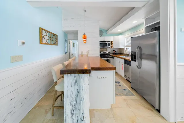 a kitchen with stainless steel appliances a refrigerator and a stove