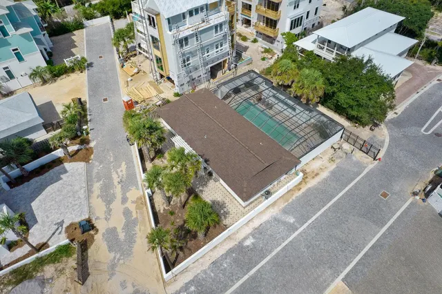 an aerial view of multiple houses with yard