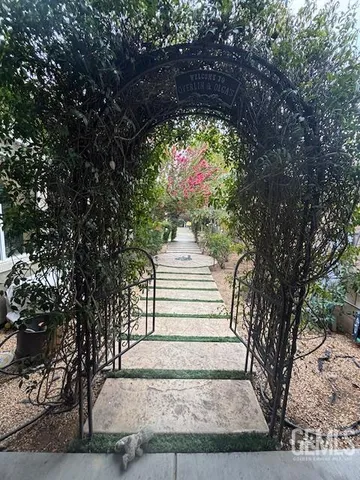 a view of a pathway of a house with a tree