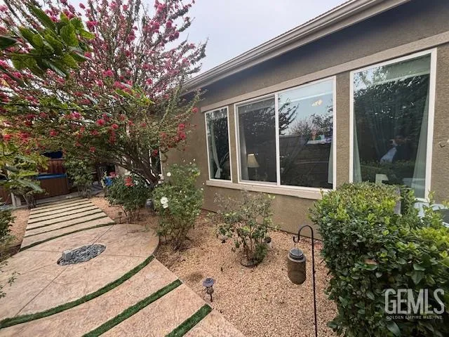 a view of a house with backyard sitting area and garden