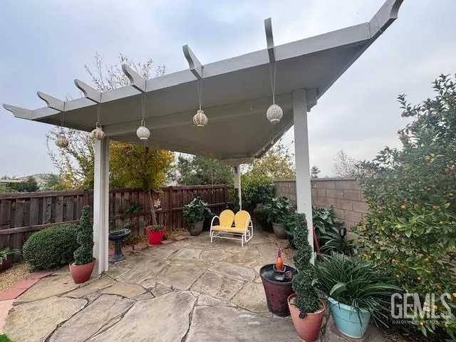 a backyard of a house with a table and chairs