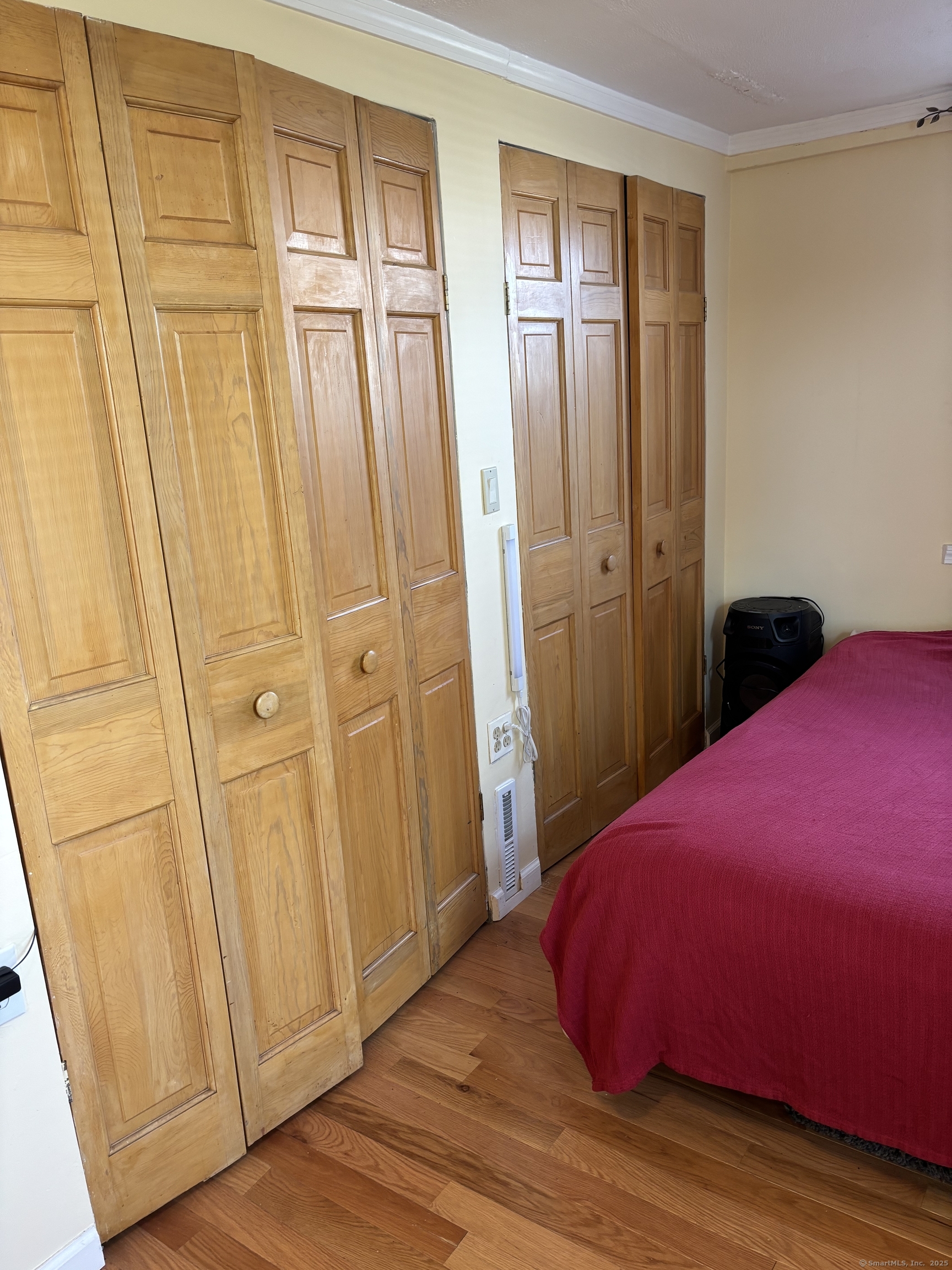 15 Harding Avenue Stratford, CT 06615 - Photo 12 of 38 a bedroom with a bed and wooden floor