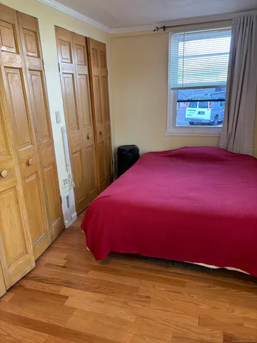 a bedroom with a bed and a window