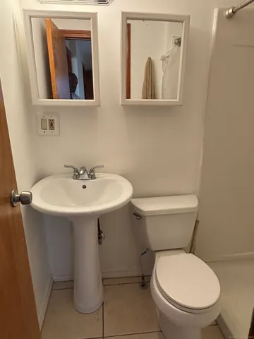 a white toilet sitting next to a bathroom sink