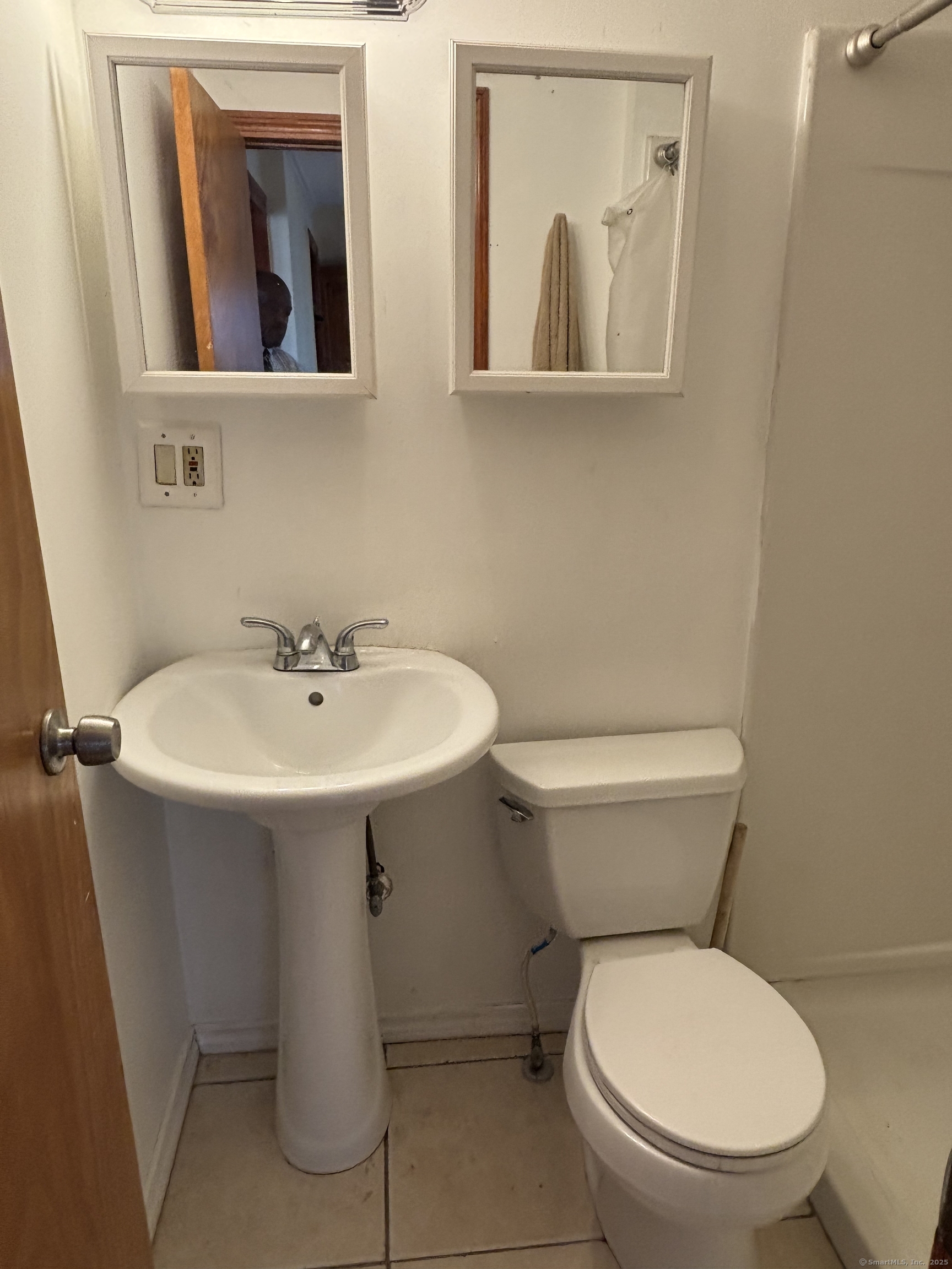 15 Harding Avenue Stratford, CT 06615 - Photo 17 of 38 a white toilet sitting next to a bathroom sink