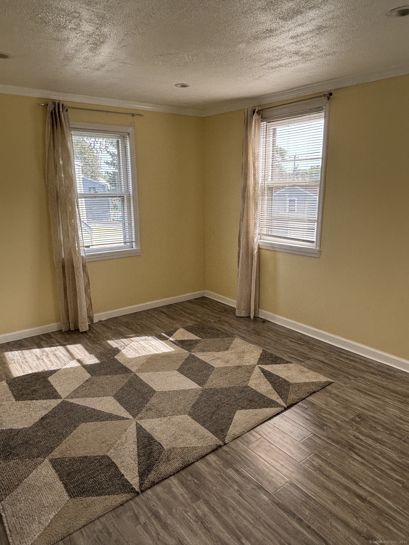 15 Harding Avenue Stratford, CT 06615 - Photo 18 of 38 a view of a livingroom with wooden floor and window