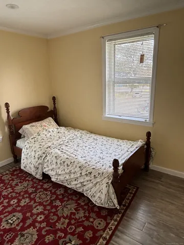 a bed sitting in a bedroom next to a window
