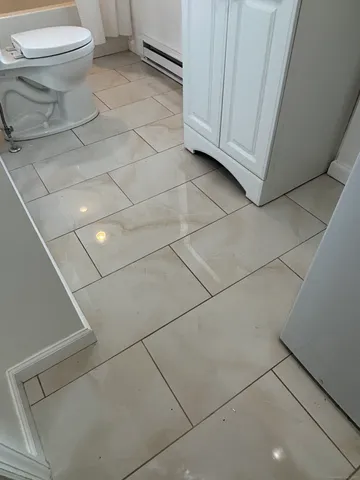 a bathroom with a toilet and a washing machine in a bathroom