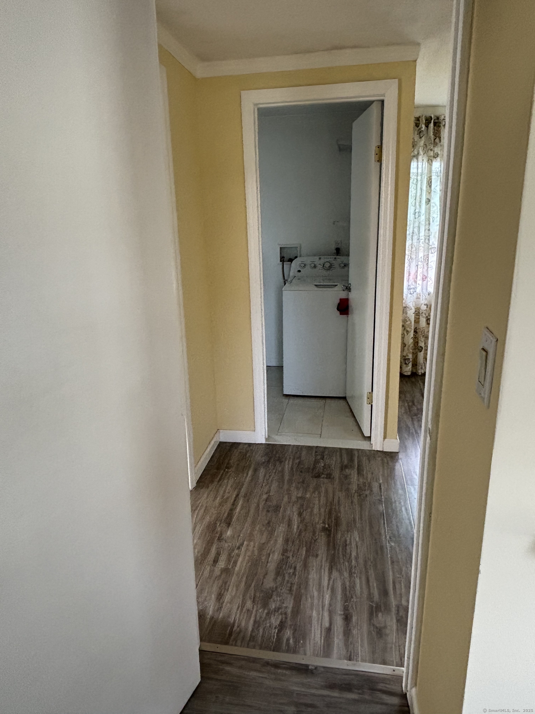 15 Harding Avenue Stratford, CT 06615 - Photo 35 of 38 a view of a hallway with wooden floor and a bathroom