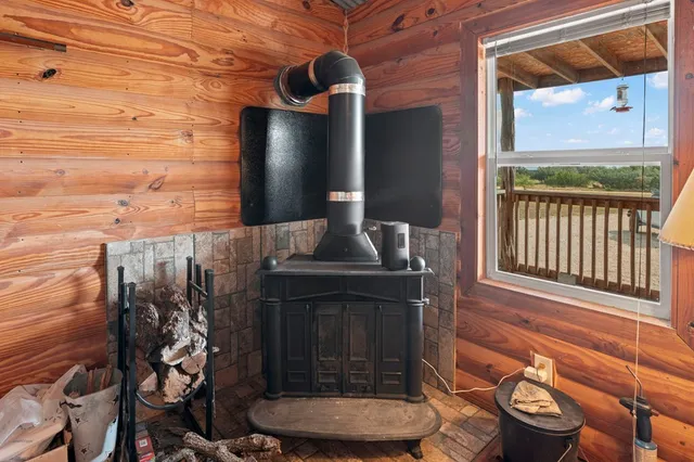 a walk in closet with clothes and shoes