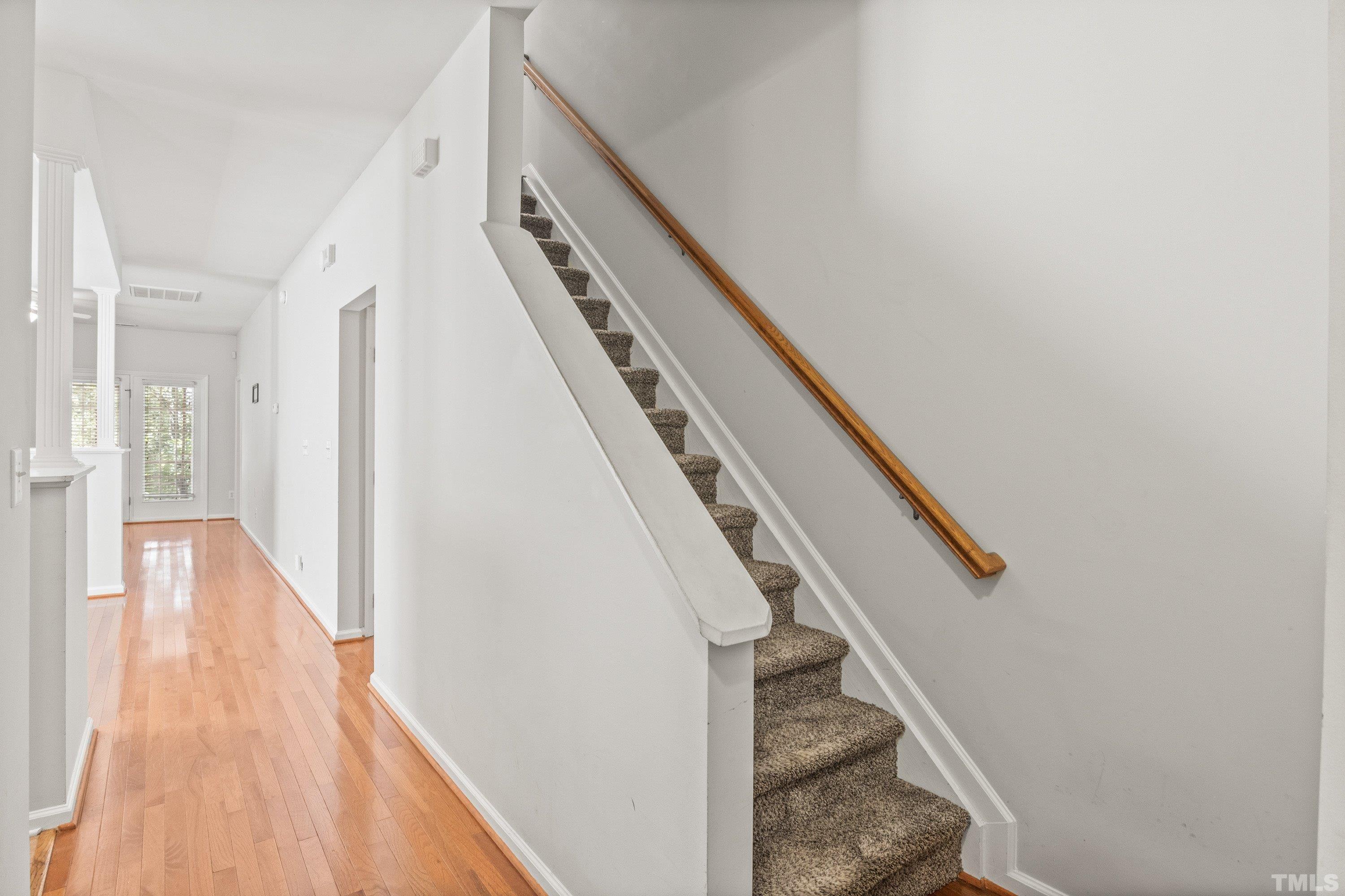 5355 Sahalee Way Raleigh, NC 27604 - Photo 13 of 42 a view of a hallway with wooden floor and staircase