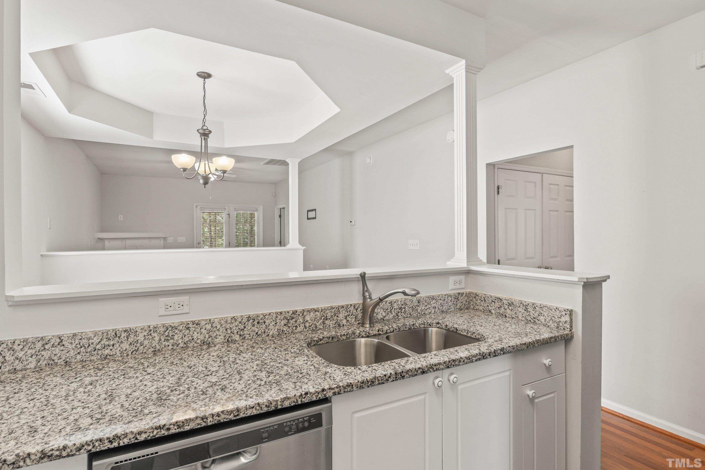 5355 Sahalee Way Raleigh, NC 27604 - Photo 19 of 42 a kitchen with a sink and chandelier