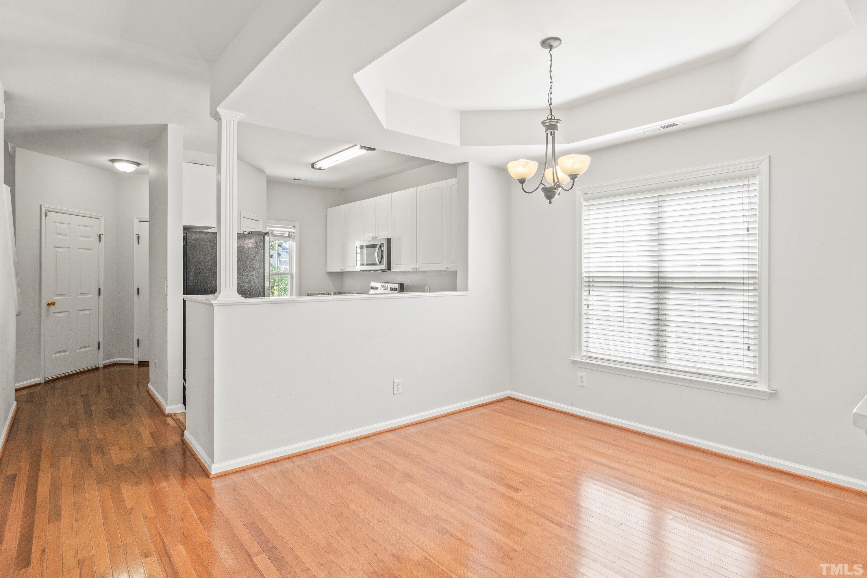 5355 Sahalee Way Raleigh, NC 27604 - Photo 21 of 42 a view of a room with wooden floor chandelier and windows