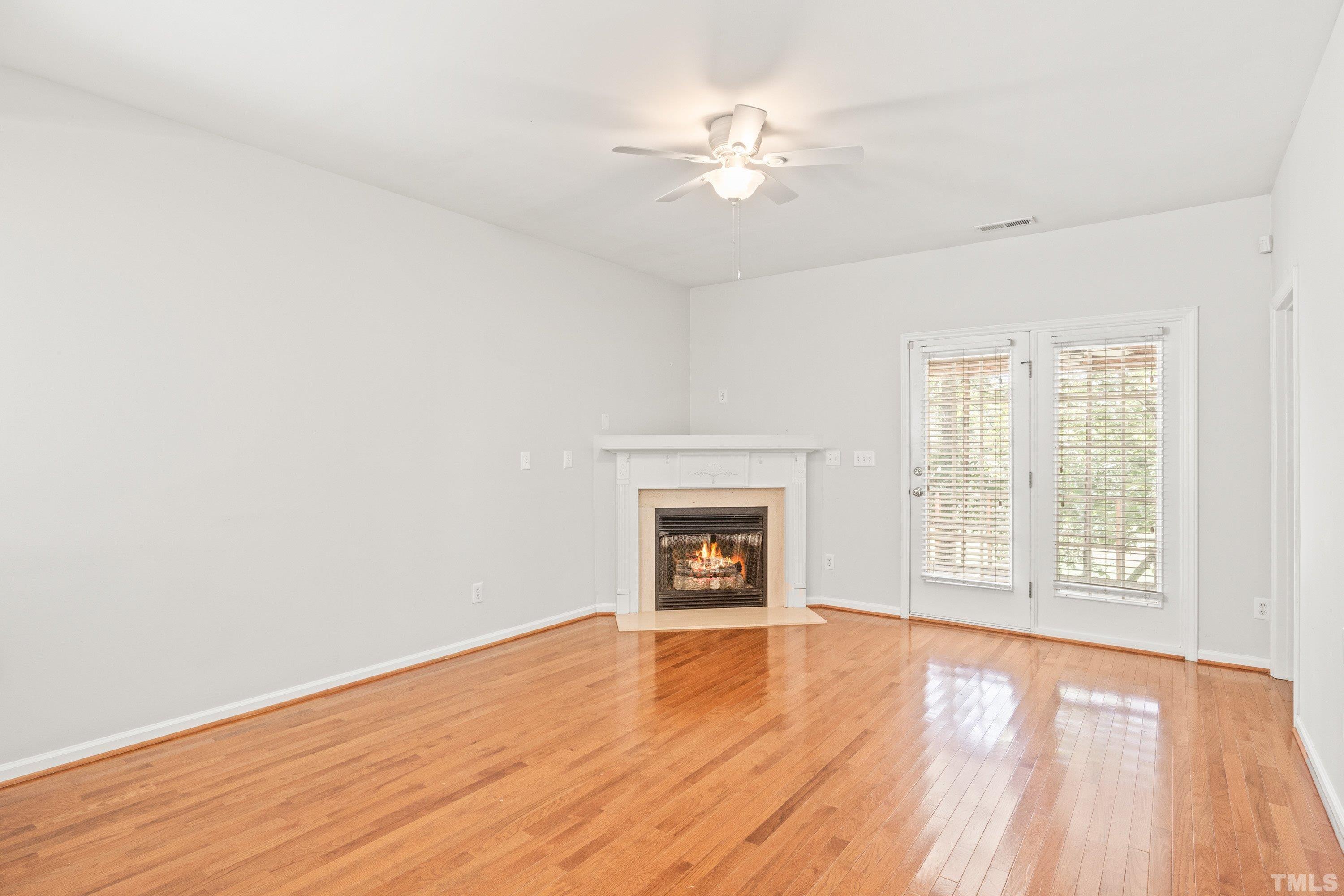 5355 Sahalee Way Raleigh, NC 27604 - Photo 22 of 42 an empty room with wooden floor fan and windows