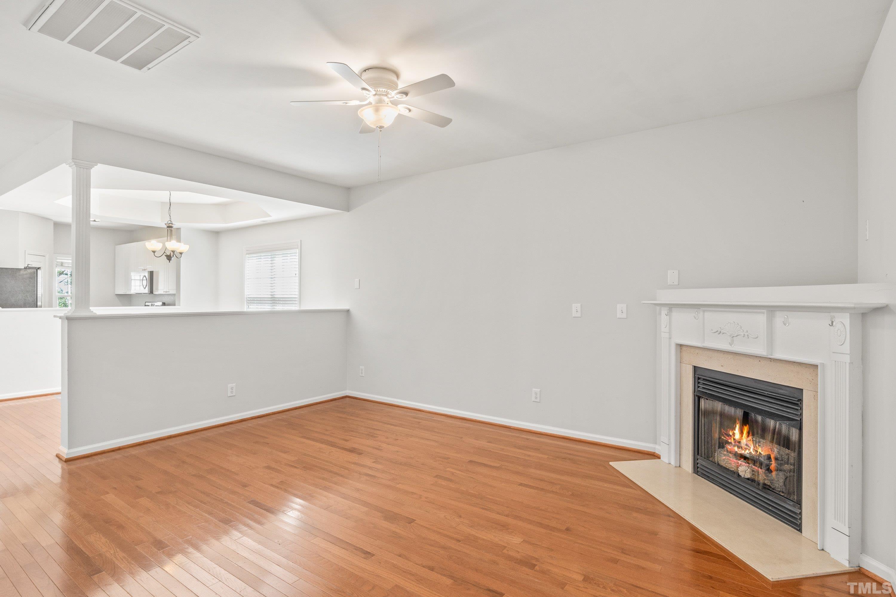 5355 Sahalee Way Raleigh, NC 27604 - Photo 23 of 42 a view of empty room with wooden floor and fireplace