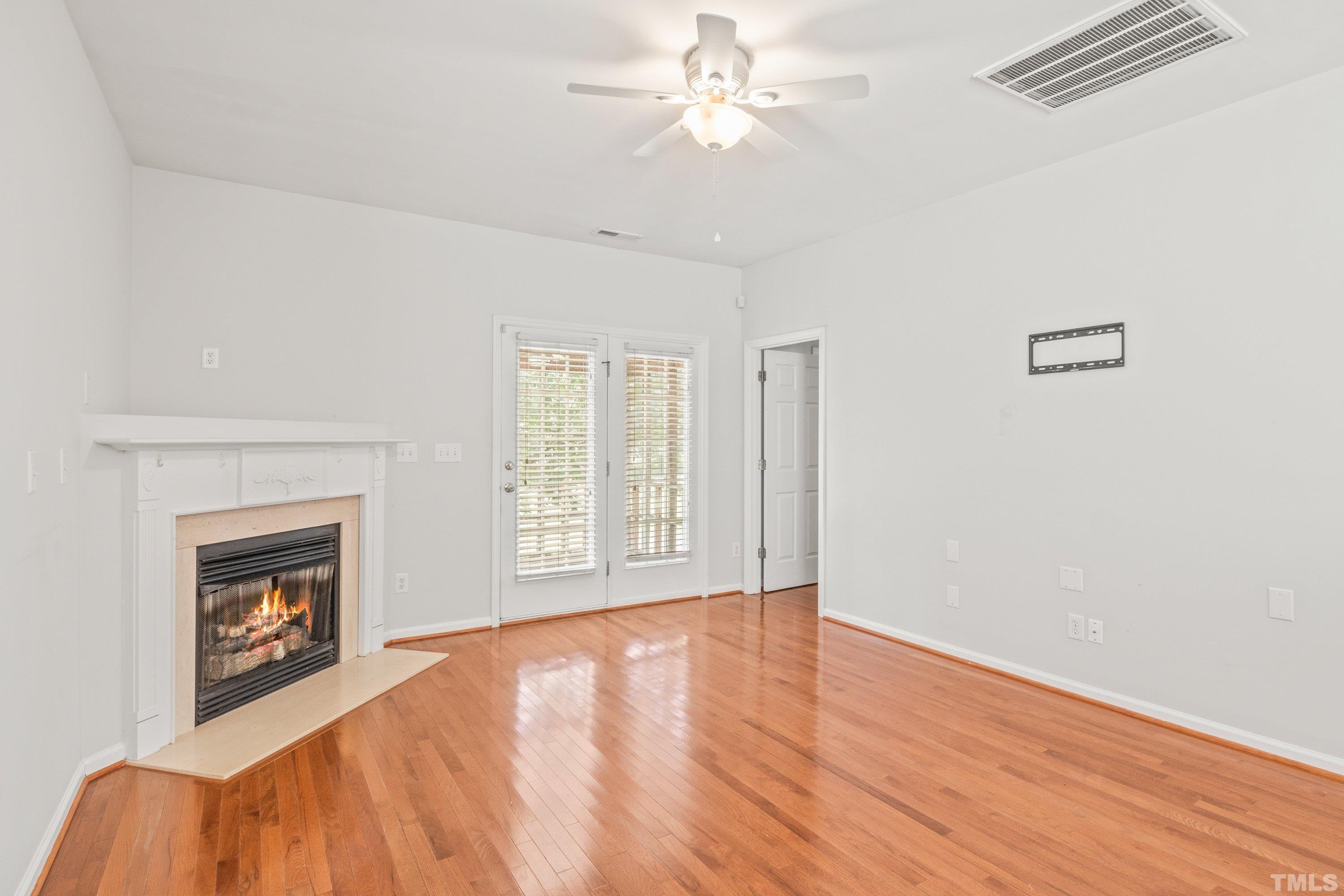 5355 Sahalee Way Raleigh, NC 27604 - Photo 25 of 42 a view of empty room with wooden floor and fan