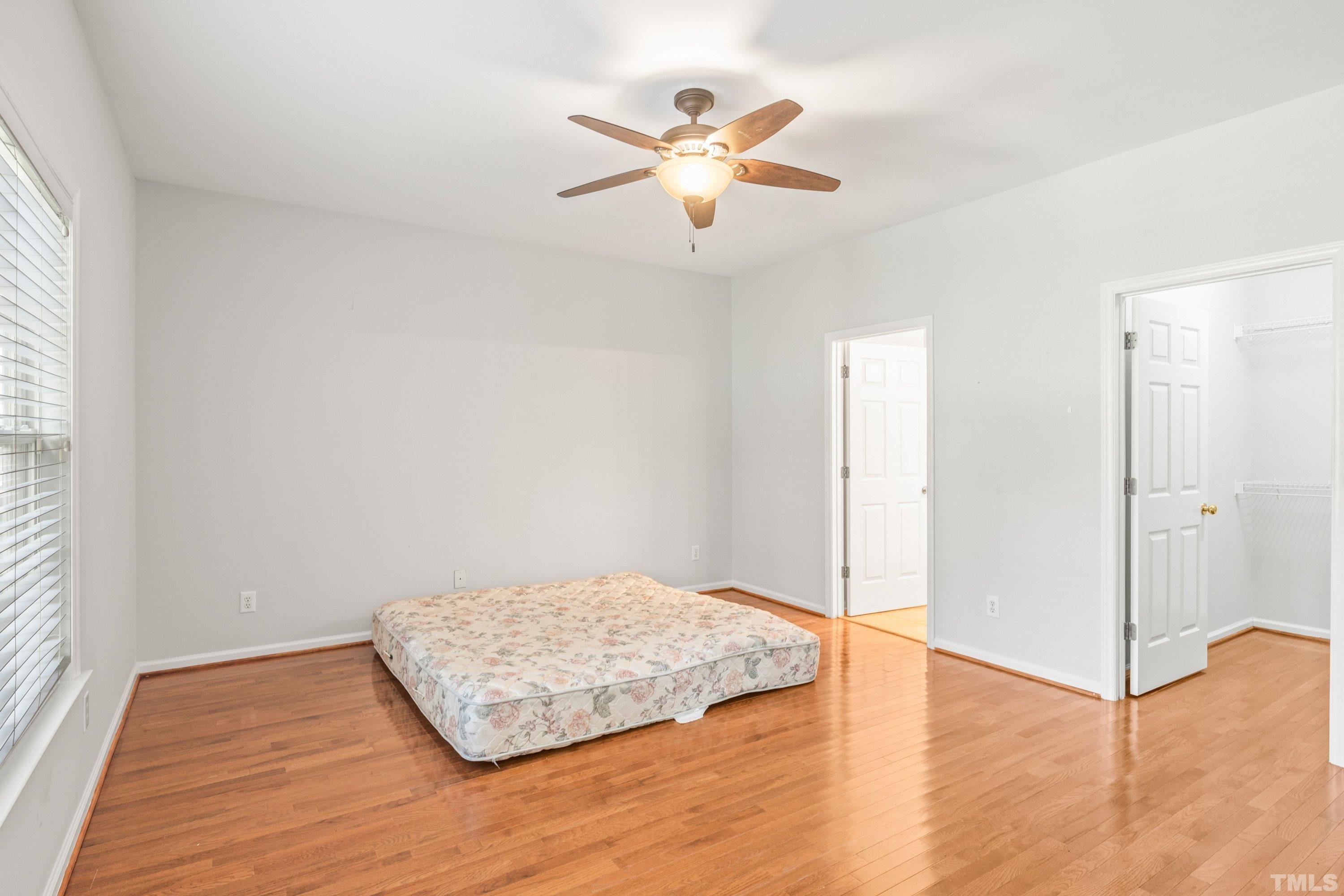 5355 Sahalee Way Raleigh, NC 27604 - Photo 26 of 42 an empty room with wooden floor and ceiling fan