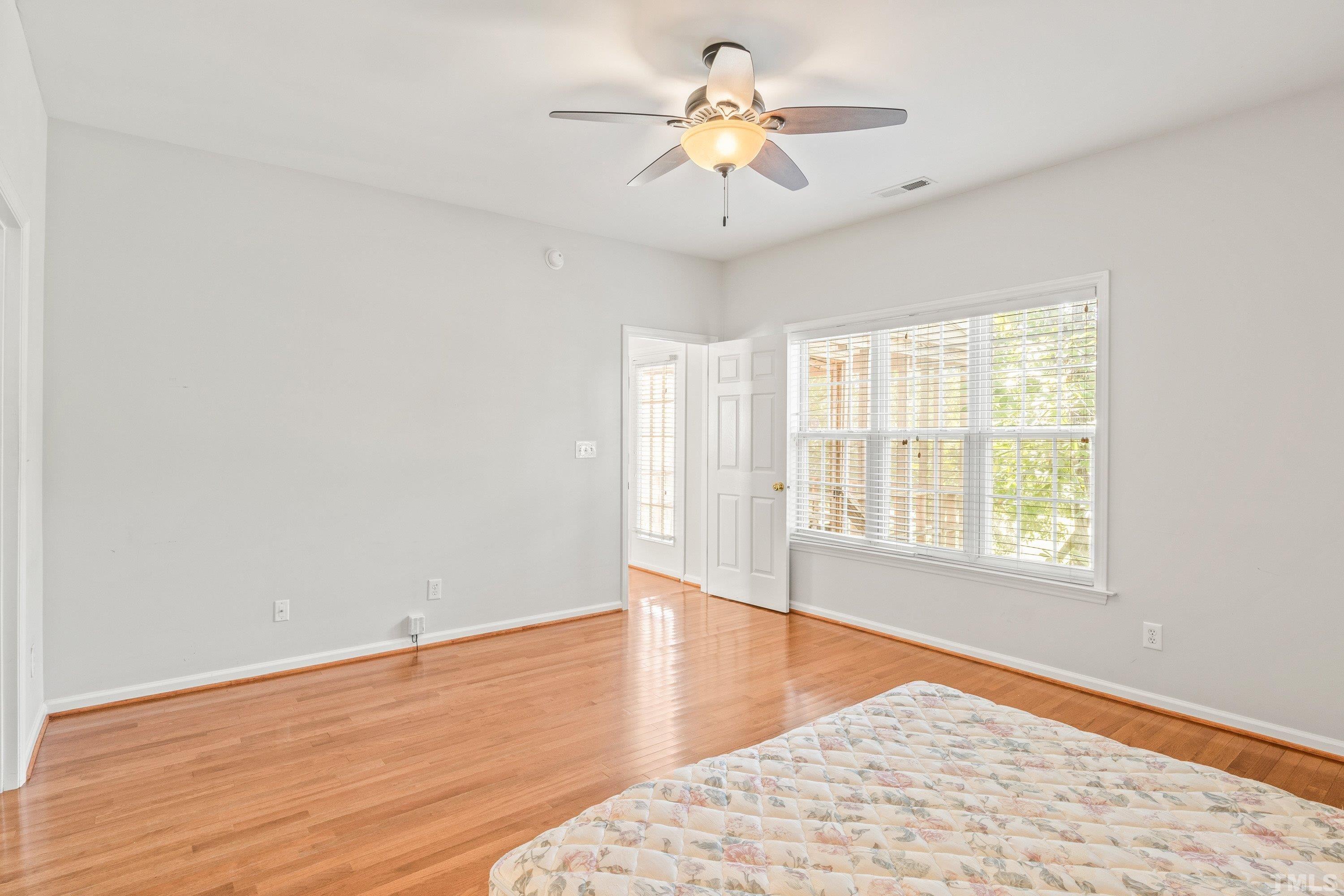 5355 Sahalee Way Raleigh, NC 27604 - Photo 29 of 42 wooden floor in an empty room with a window
