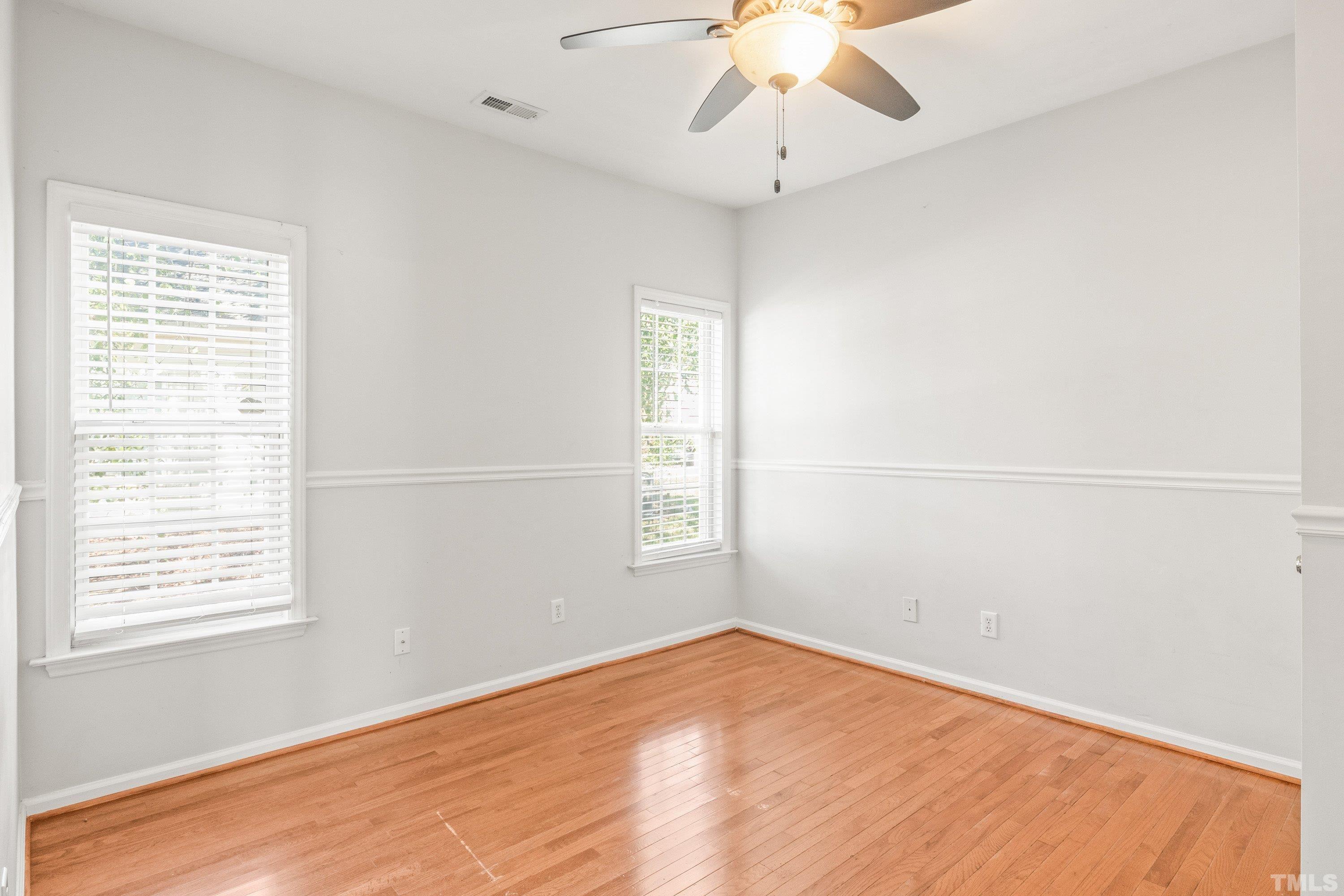 5355 Sahalee Way Raleigh, NC 27604 - Photo 33 of 42 an empty room with a window and chandelier fan
