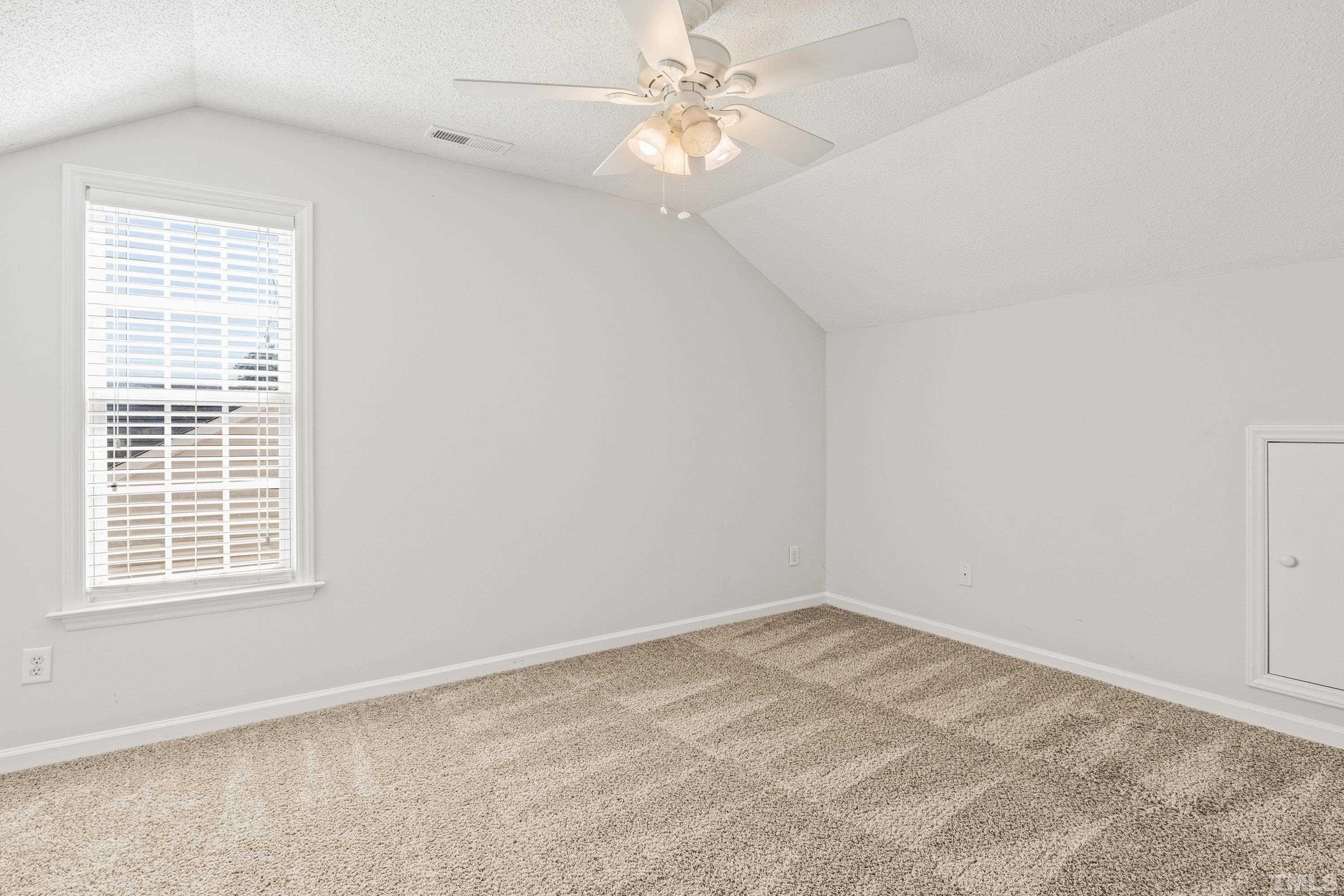 5355 Sahalee Way Raleigh, NC 27604 - Photo 37 of 42 an empty room with a window and a fan