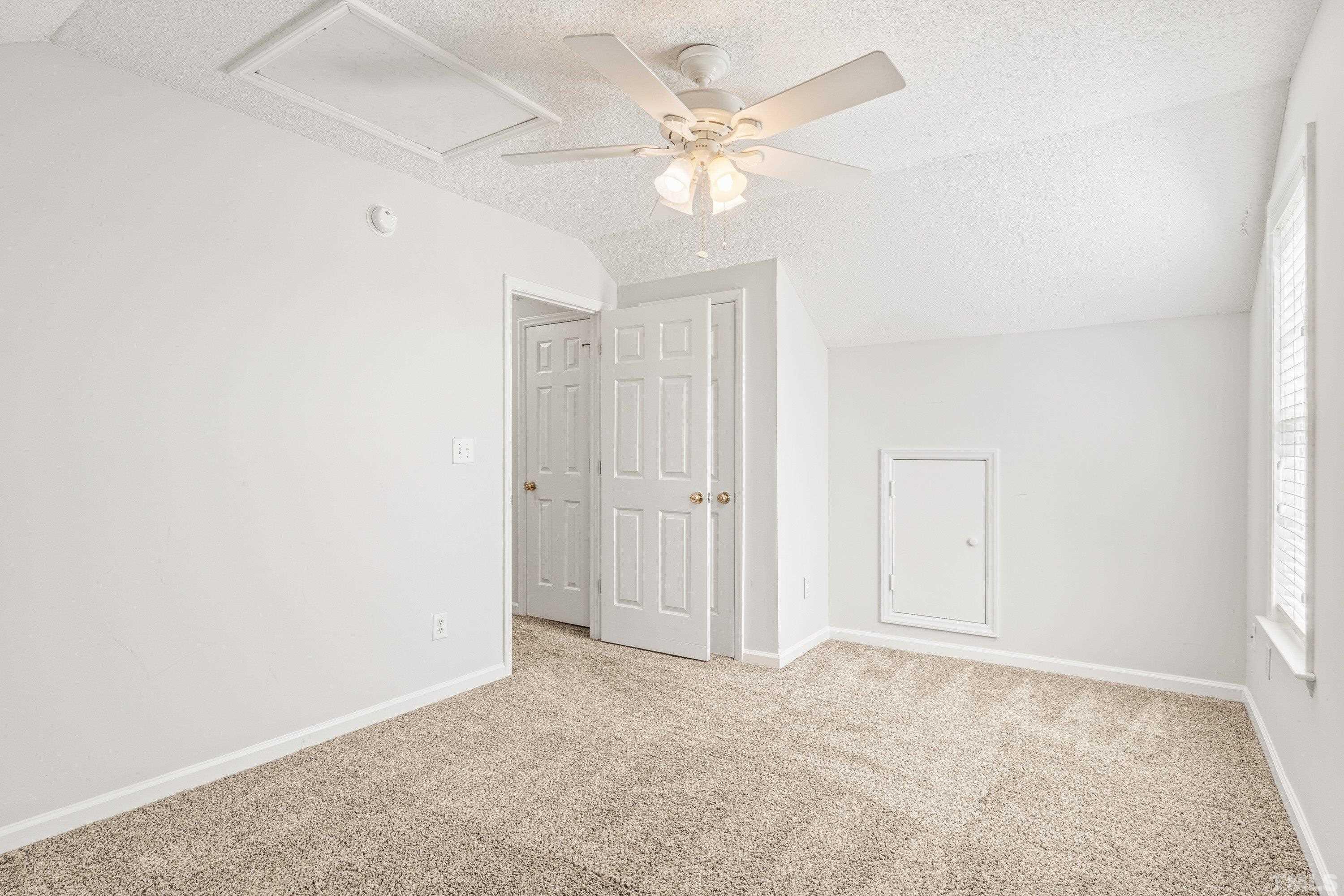 5355 Sahalee Way Raleigh, NC 27604 - Photo 38 of 42 an empty room with a ceiling fan and a window